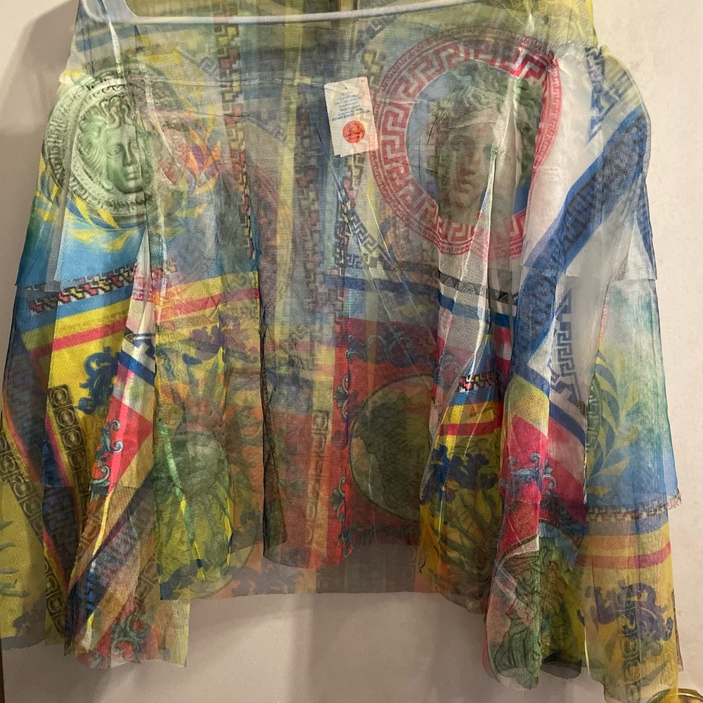 Colorful Patterned see through top with flared arms.